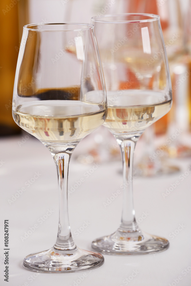 Glasses of white wine on table closeup Glasses of white wine on table closeup