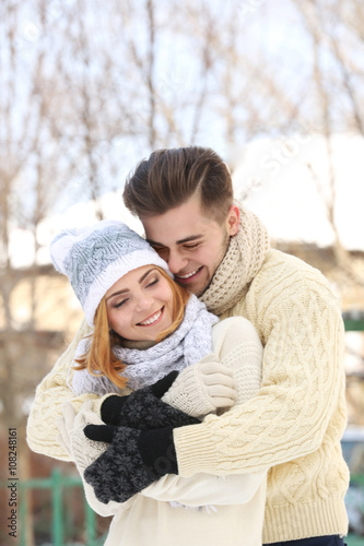 Young couple embracing outd...