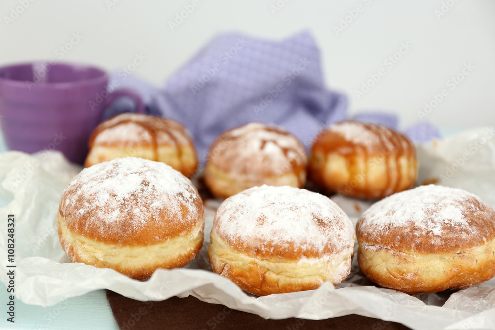Delicious donuts with caramel on parchment closeup Delicious donuts with caramel on parchment closeup