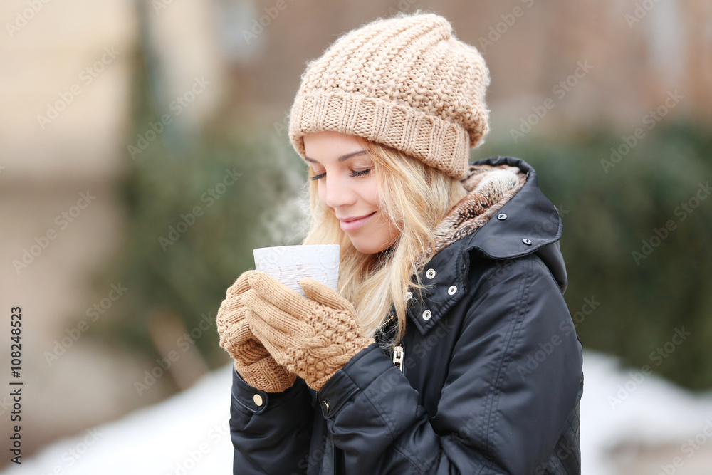 Beautiful girl enjoying a cup of tea outdoors Beautiful girl enjoying a cup of tea outdoors