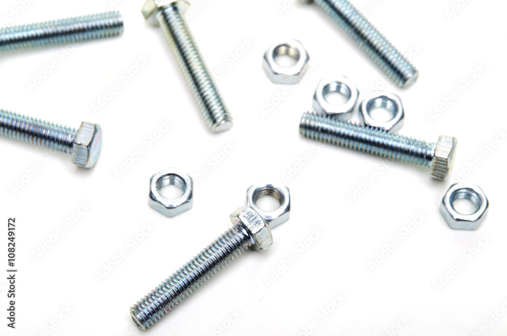 Bolts and nuts and washers on white paper Bolts and nuts and washers on white paper