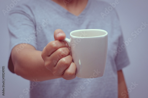 hands holding coffee cup with filter effect retro vintage style