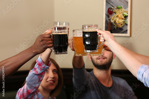 Friends drinking beer in pub