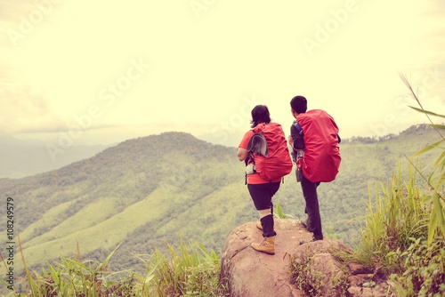 Caucasian couple takes rest on top of mountain, Winner on mountain top, Sport and active life.