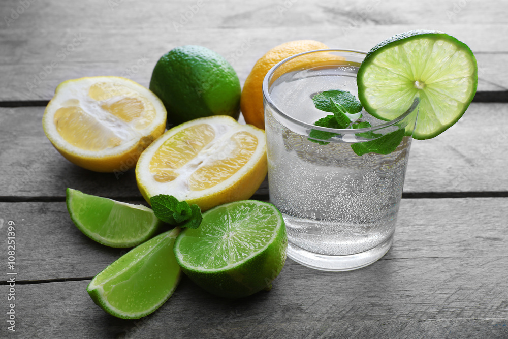 Glass of lemon soda with fresh mint on rustic wooden background Glass of lemon soda with fresh mint on rustic wooden background