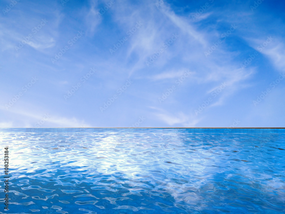 Fototapeta infinity pool with blue sea and blue sky