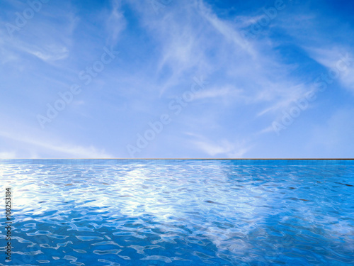 infinity pool with blue sea and blue sky © phonlamaiphoto