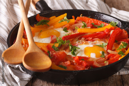 Basque breakfast: fried eggs with peppers close-up. horizontal
 photo