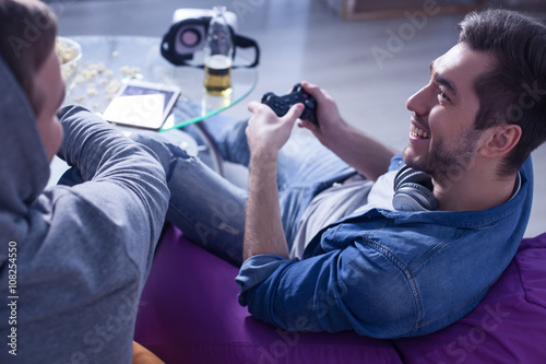 Attractive young guys are playing video game