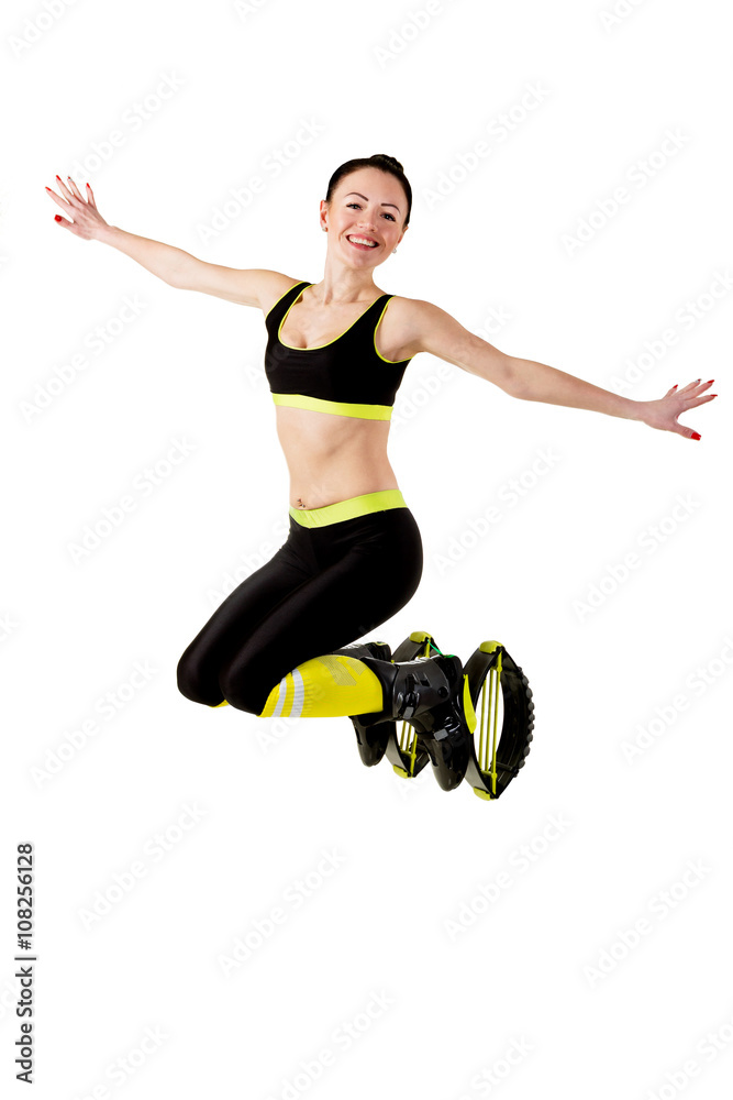 Smiling brunette girl  jumping in a kangoo jumps shoes.