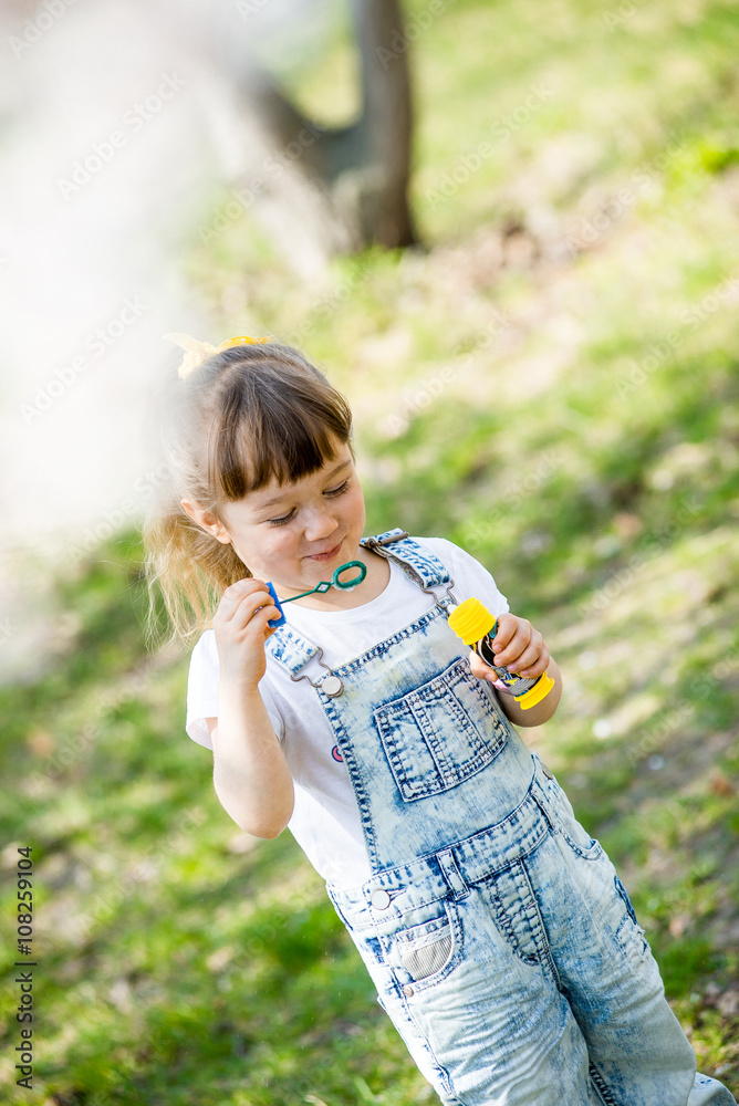 little girl inflates soap bubbles little girl inflates soap bubbles