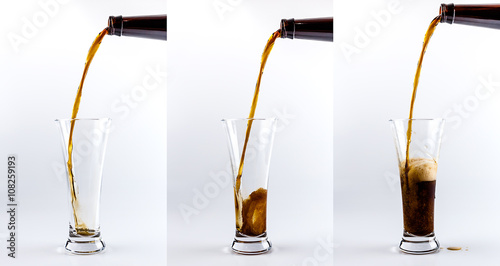 Pouring process of dark stout beer into a beer glass, splashes, drops and froth around glass