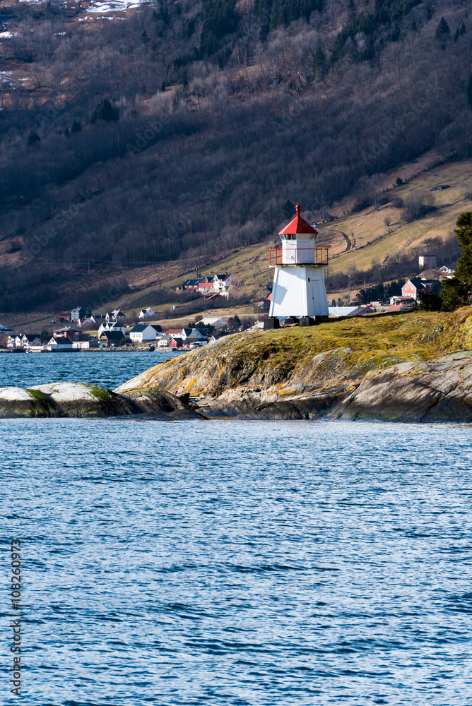 Small lighthouse in Norwegian fjord. Vertical composition