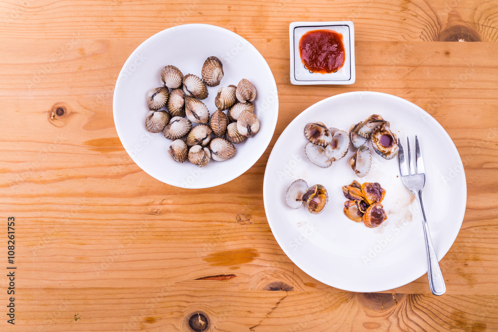 Boiled and prepared cockles with chili dip delicacy, unhealthy but popular among Asians Boiled and prepared cockles with chili dip delicacy, unhealthy but popular among Asians