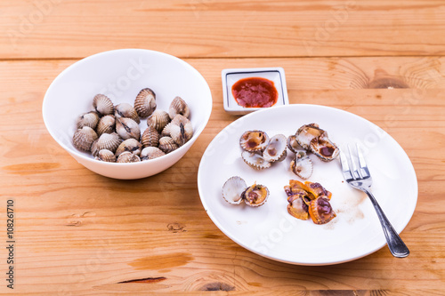 Boiled and prepared cockles with chili dip delicacy, unhealthy but popular among Asians
