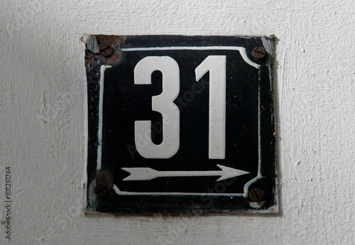 Vintage metal house number on the wall, retro house number