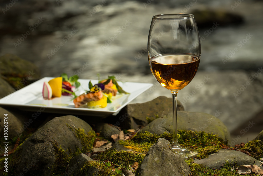 Wine glass and meal near water