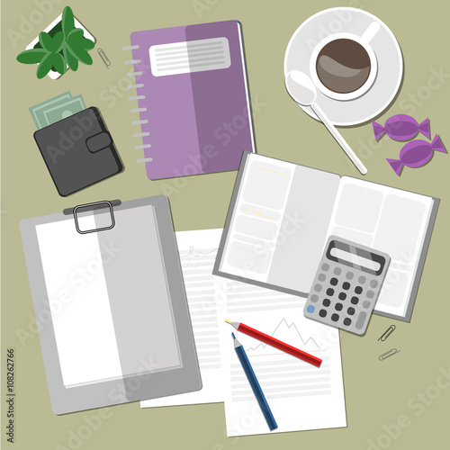 Working space with coffee, plant and clipboard.