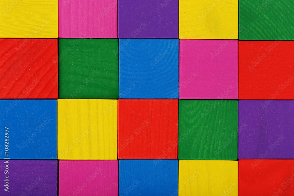 Colorful wooden toy cubes background, close up
