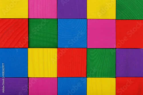Colorful wooden toy cubes background, close up