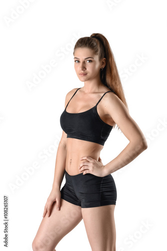 Cutout fitness woman in shorts and a tank top standing sideways © gearstd