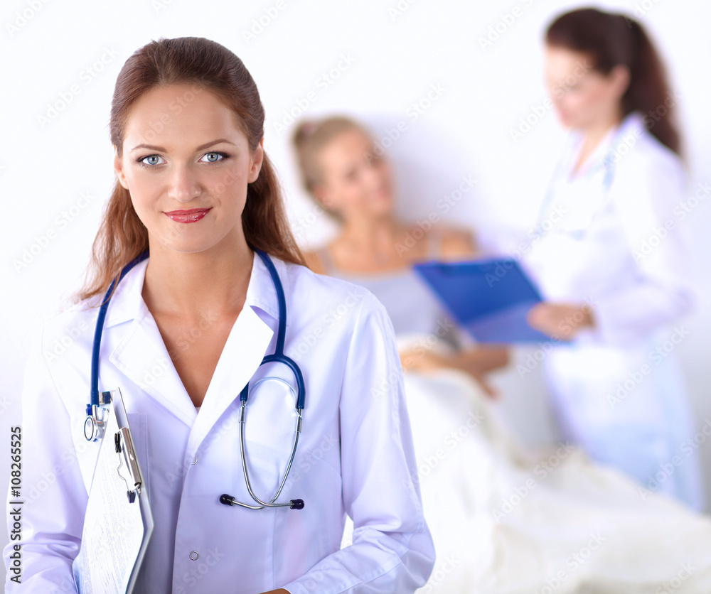 Smiling female doctor with a folder in uniform standing at hospital Smiling female doctor with a folder in uniform standing at hospital