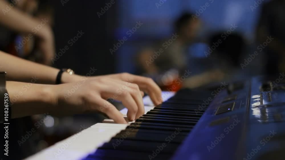 keyboard player playing on synthesizer