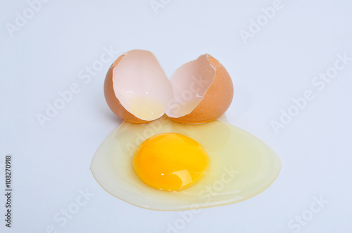 Broken egg with yolk, isolated on white background.