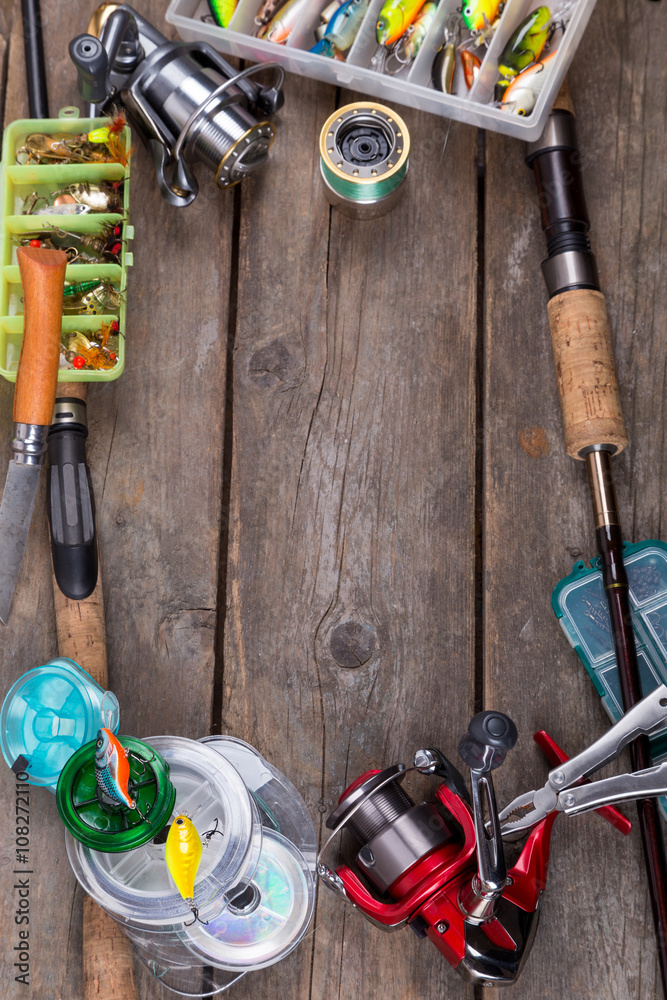 fishing tackles and baits on wooden board fishing tackles and baits on wooden board