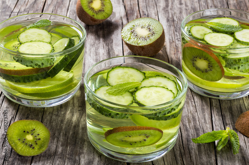 Drinks with sliced lime, kiwi fruit, cucumber
