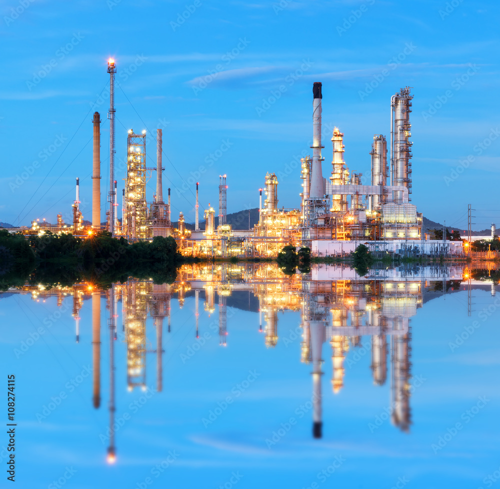 Oil refinery at twilight - petrochemical industry with water reflect