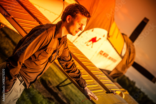 Outdoor portrait of attractive man at airport with vintage old propeller plane in Rybnik Gotartowice Poland