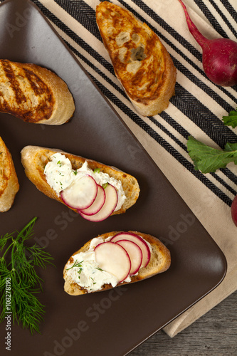 Bread Toasts with White Cheese and Radishes. Selective focus.
