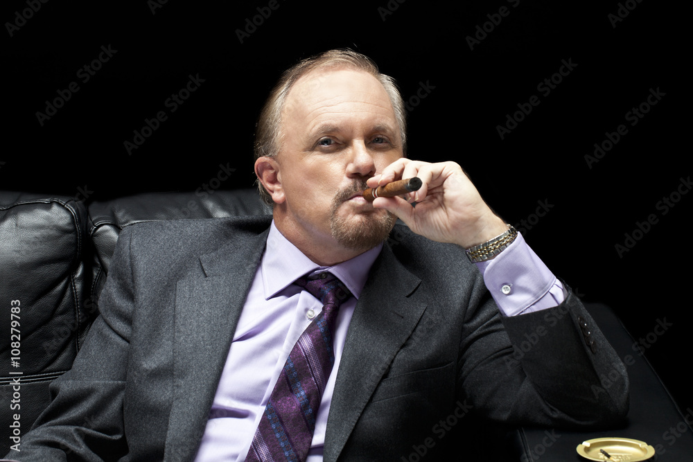 mafia boss smoking a cigar. Stock Photo | Adobe Stock