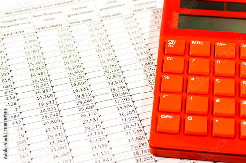 Red electronic calculator on spreadsheet photo