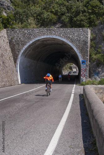 Cyclists enter a tunnel Capo d'Orso, Amalfi coast, Italy © gigadesign