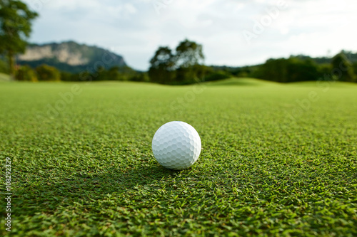 white golf ball on fairway with the green background in the coun