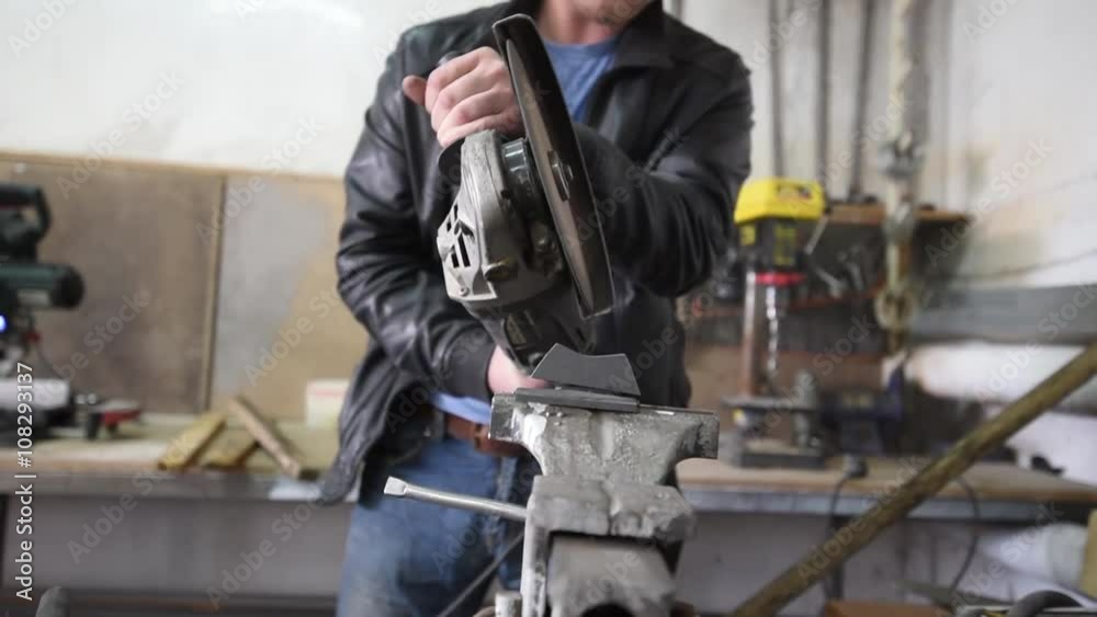 Worker with Angle Grinder does Metalworking in Industrial Environment Worker with Angle Grinder does Metalworking in Industrial Environment