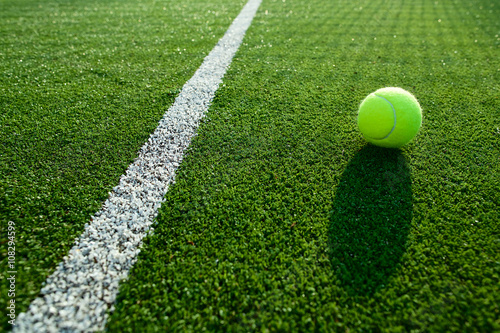 soft focus of tennis ball on tennis grass court good for backgro © kireewongfoto