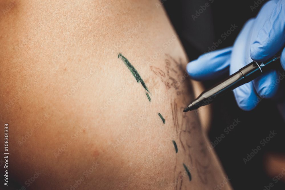master tattoo artist makes a mark on the skin before applying the tattoo master tattoo artist makes a mark on the skin before applying the tattoo