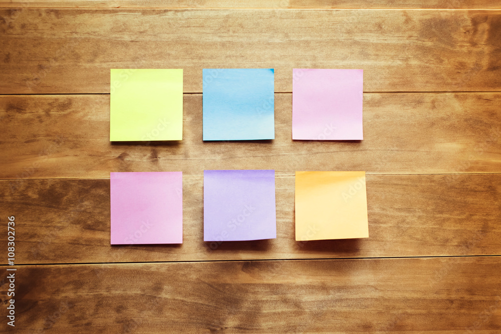 Sticky notes on a wood desk Sticky notes on a wood desk