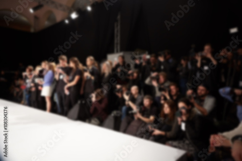 blurred image of group audience at fashion show stage