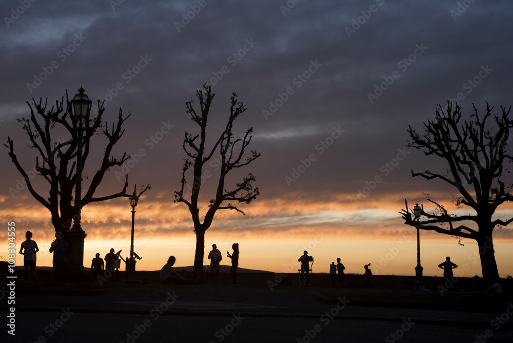 Silhouettes of people at sunset