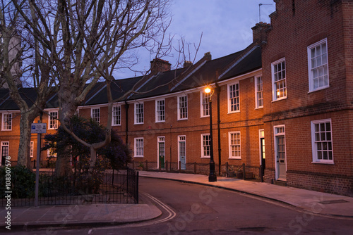 Restored Edwardian brick houses on a local road at night 