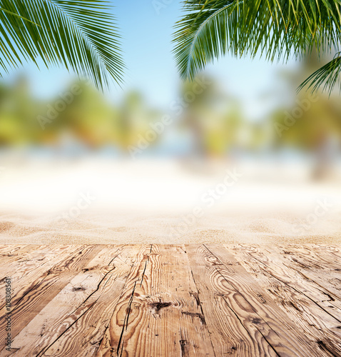Fototapeta Naklejka Na Ścianę i Meble -  Empty wooden planks with blur beach on background