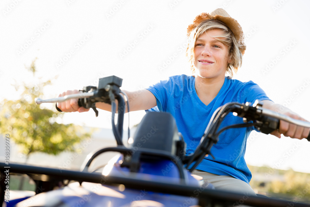 Boy riding farm truck in vineyard Boy riding farm truck in vineyard