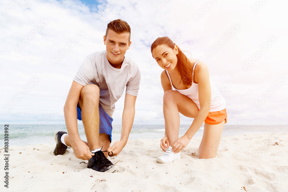 Runners lace their shoes and prepare to jogging Runners lace their shoes and prepare to jogging