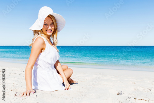 Wallpaper Mural Young woman relaxing on the beach Torontodigital.ca