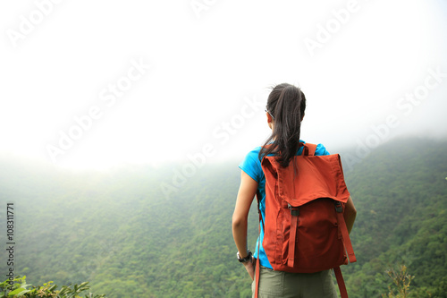 young asian woman enjoy the view at mountain peak