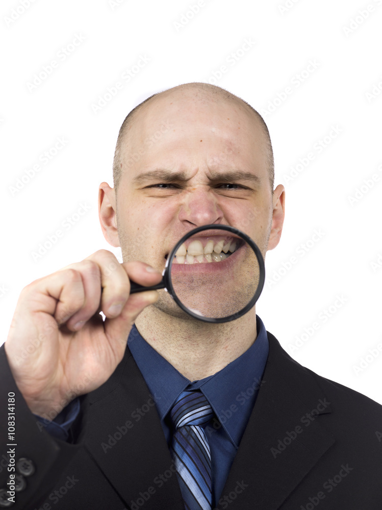 man with magnifying glass showing his teeth man with magnifying glass showing his teeth